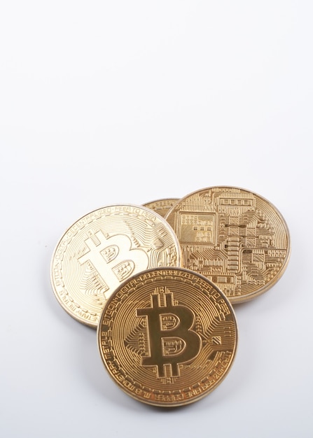 Heap of golden bitcoins isolated on white background close up with copy space