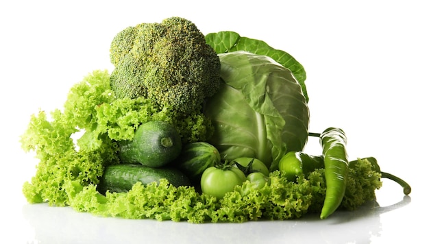 Heap of green vegetables isolated on white