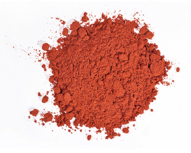 Heap of ground paprika on a white background