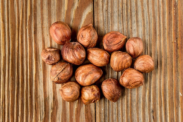 Heap of hazelnuts on a wooden table