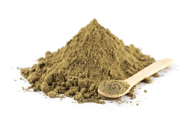 A heap of hemp protein with a wooden spoon on a white background