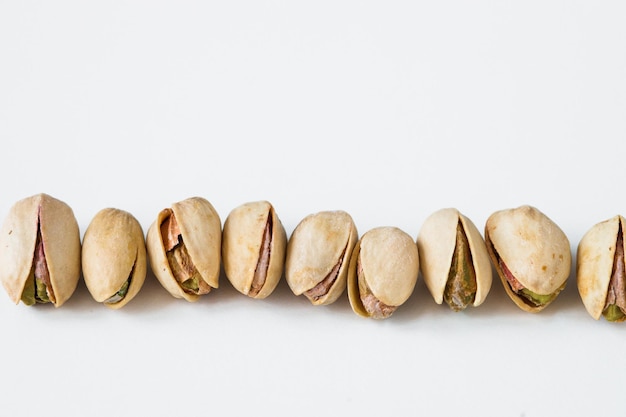 Heap of pistachios isolated on white background Overhead