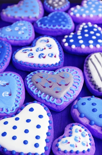 Heap of purple blue heart shaped with beautiful patterned royal icing cookies