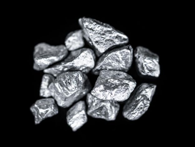 Heap of silver nuggets isolated on black background