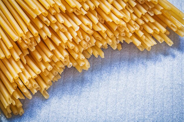 Heap of spaghetti on blue background food and drink concept