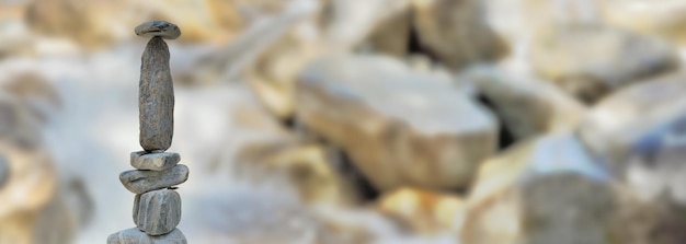 Heap of stones in front of water fall in rock blurred