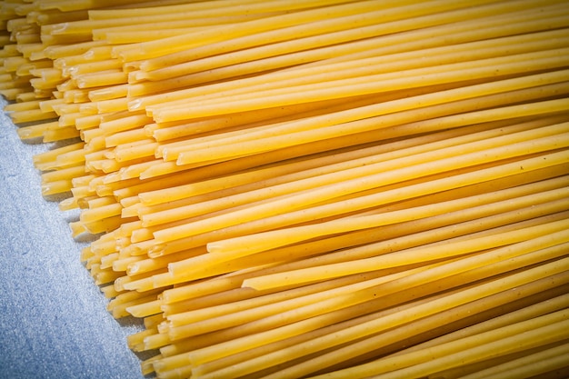 Heap of thin spaghetti on blue background directly above food and drink concept