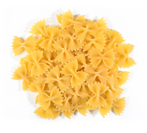 Heap of uncooked italian pasta farfalle on a white background