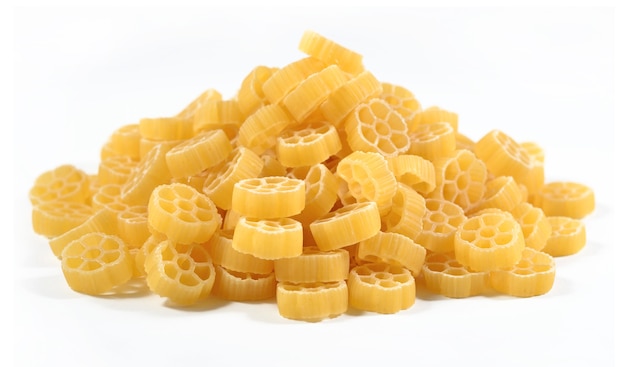 Heap of uncooked italian pasta rotelle on a white background