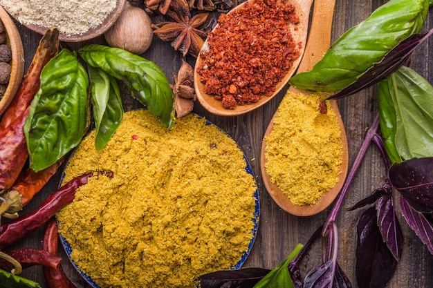 Heaps of various ground spices on wooden wall. Georgian spices, Indian spices, Arabian spices. Spice variety. Herbs and spices