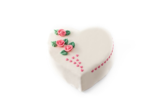 Heart cake for St. Valentine's Day,  decorated with roses and pink sugar hearts isolated on white background