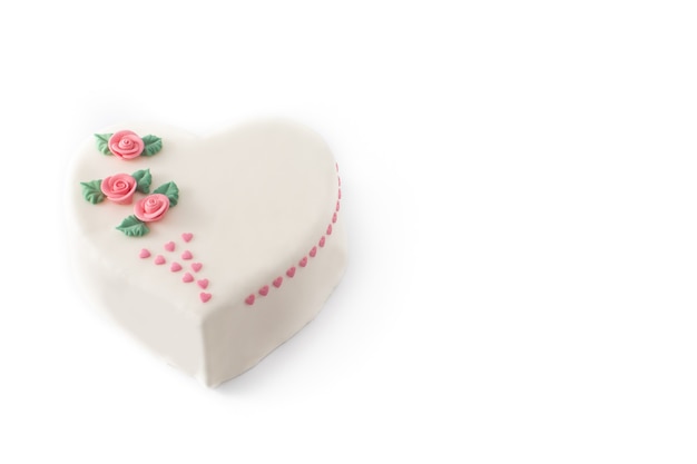 Heart cake for St. Valentine's Day,  decorated with roses and pink sugar hearts isolated on white background