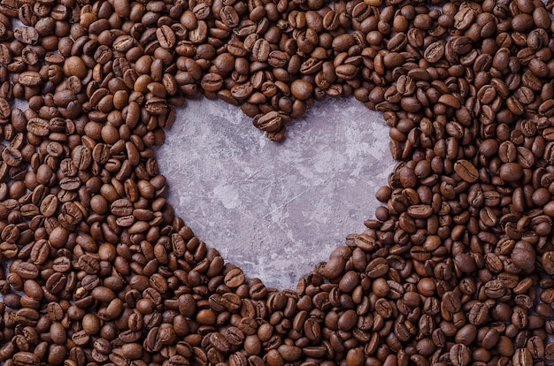 Heart of coffee. Grains of coffee are laid out on background in the form of heart