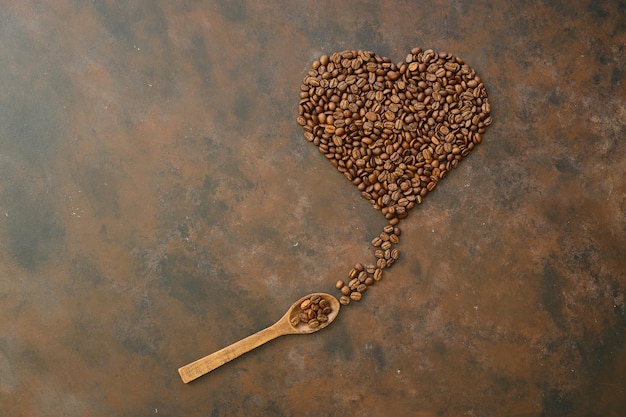 Heart coffee Roasted coffee beans in the shape of heart on bright stone background Concept of coffee love