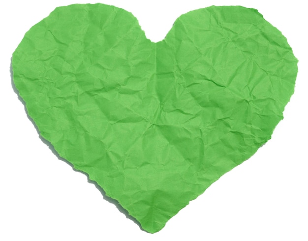 A heart cut out of green paper on a white isolated background an element for a designer