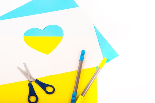 Heart cut out of paper and painted in blue and yellow colors as symble of Ukraine Creativity as support of Ukraine