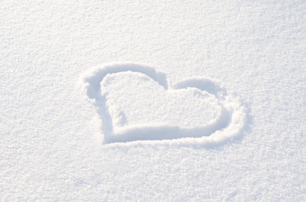 Heart drawn on the fresh white snow