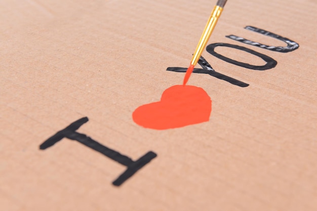 Heart drawn in pencil on a paper sheet close-up