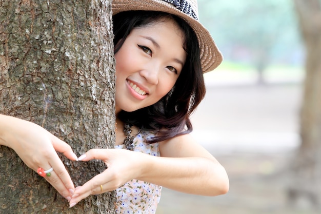 Heart from hands on a tree trunk 