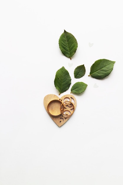 Photo heart and gold wedding rings on a white background