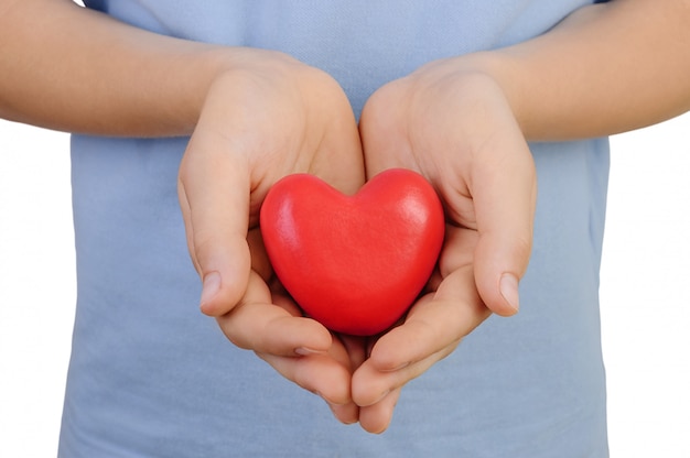 Heart in the hands of a boy on a white