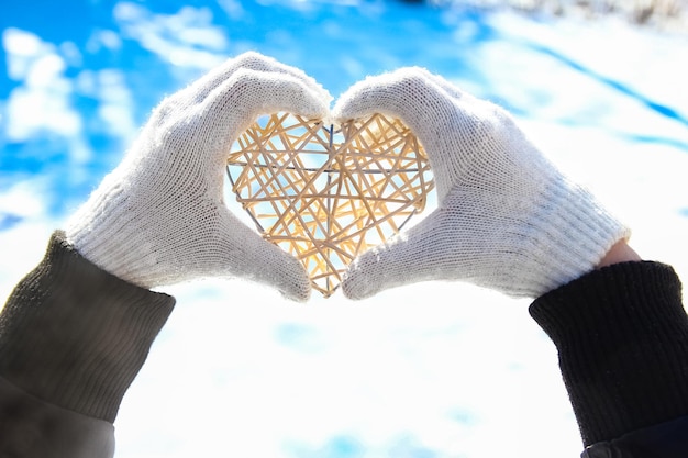 A Heart in the hands of a girl against the sky Valentine's day in a park in nature