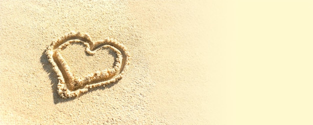 Photo heart is drawn on beach sand painted heart on sand template banner text space