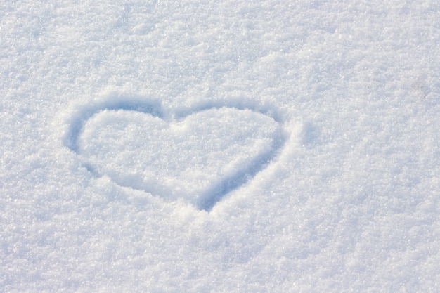 The heart is drawn in the snow.