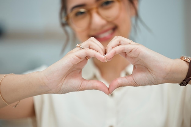 Heart love and happy with hand of woman for thank you support and peace Kindness hope and motivation symbol with closeup of female person and sign at home for emoji care and romance icon