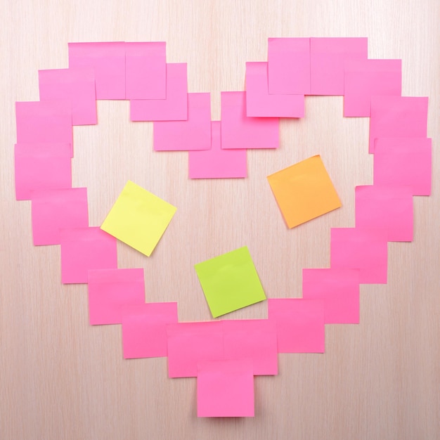 Heart made of adhesive note close-up