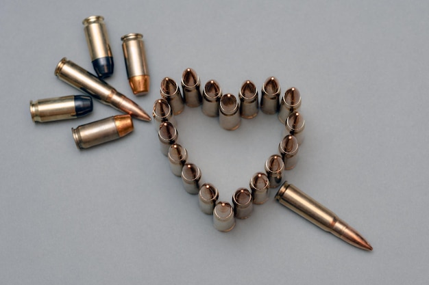 A heart made of bullets is surrounded by a heart made of bullets.