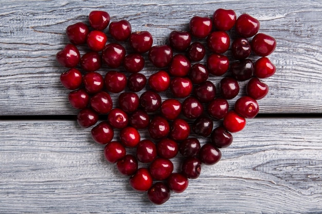 Heart made of cherry dark fruit on wooden surface summer fills heart with joy make life brighter