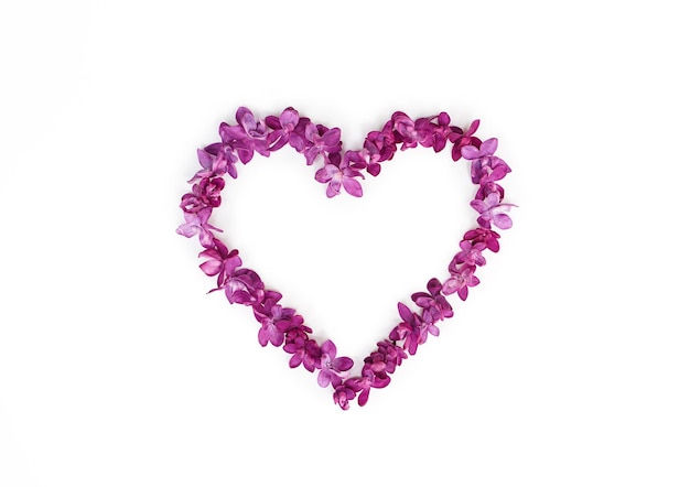 Heart made of lilac flowers isolated on a white background Top view copy space