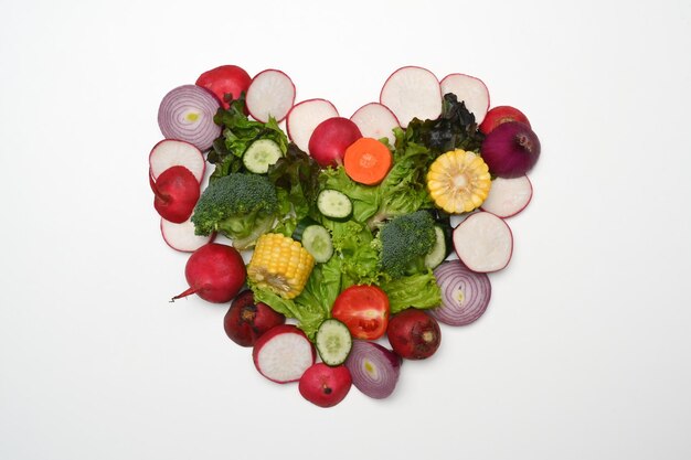 Heart made of various raw vegetables Flat lay top view and healthy food concept