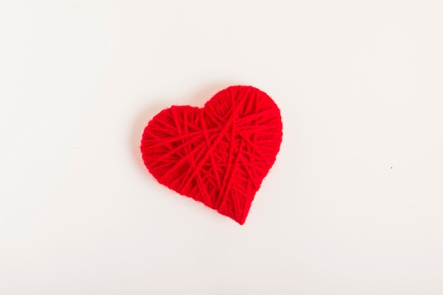 heart made of wool threads on a white background