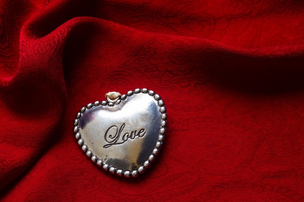 Heart on red silk background