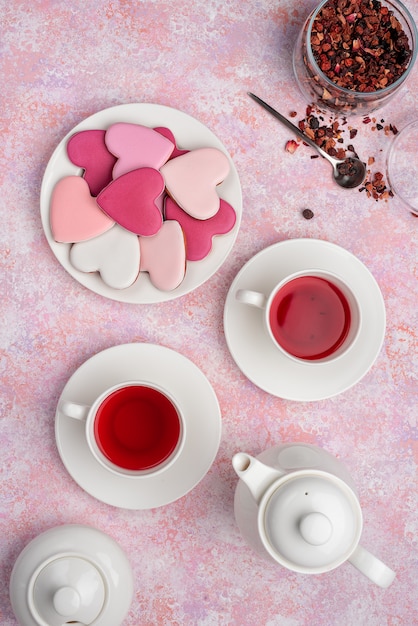 Heart shape cookies with icing with berry tea