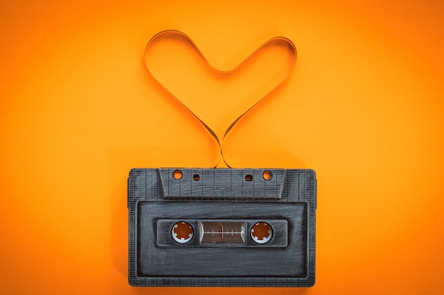 heart shape from cassette tape over paper background