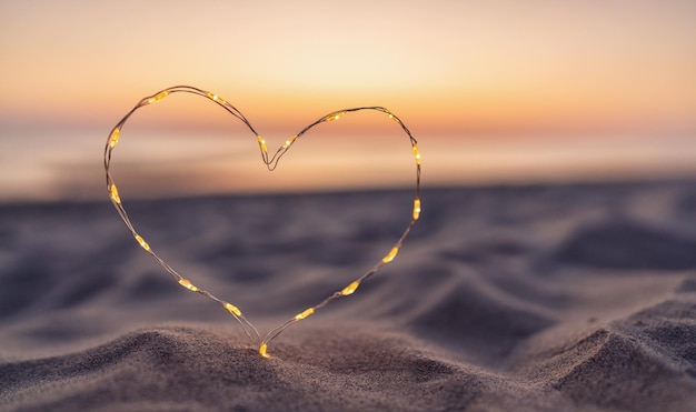 Heart shape made of led lights at the beach sand