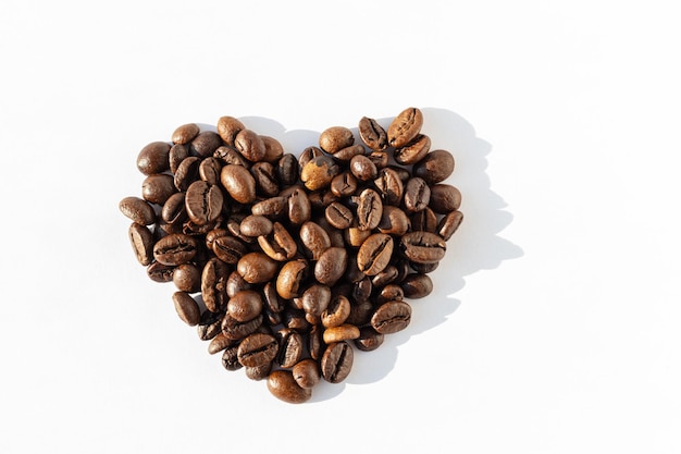 Heart shape of Robusta Arabica coffee beans isolated on white background I love coffee Coffee beans for latte cappuccino mocha americano coffee macchiato Coffee love concept