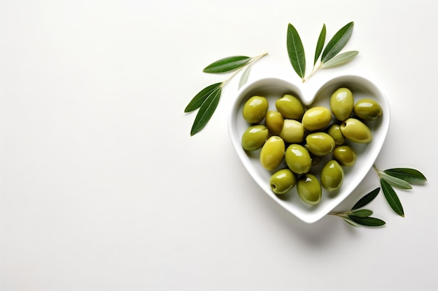 a heart shaped bowl filled with green olives