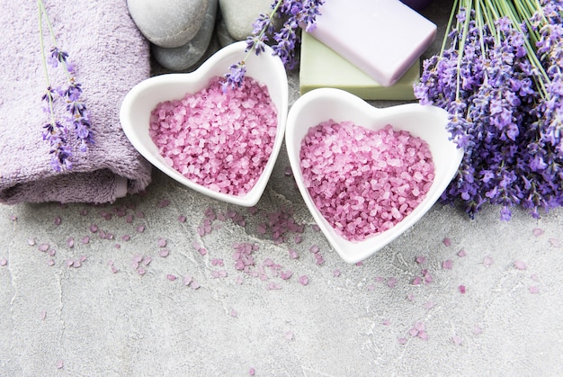 Heart-shaped bowl with sea salt, soap and  lavender flowers