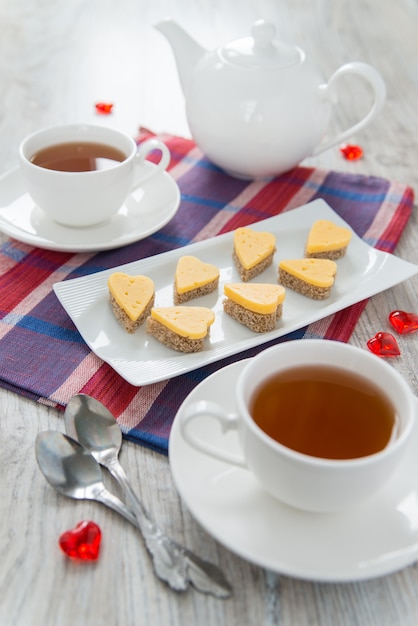 Heart shaped cheese sandwiches on a white plate