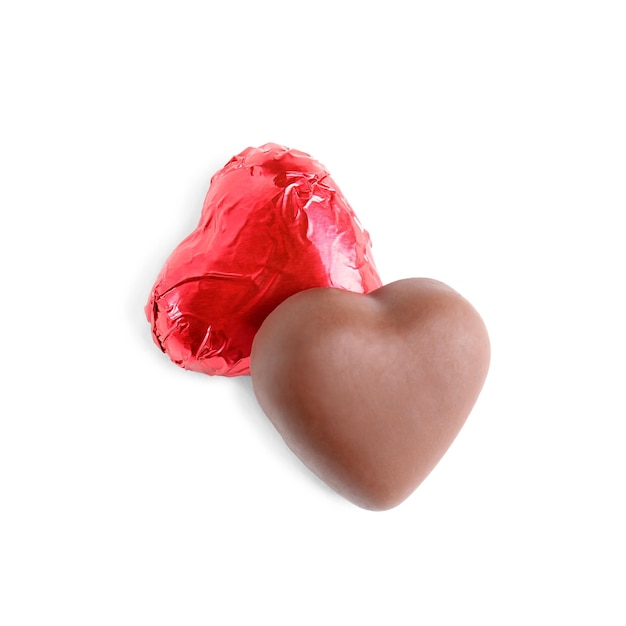 Heart shaped chocolate candies on white background top view