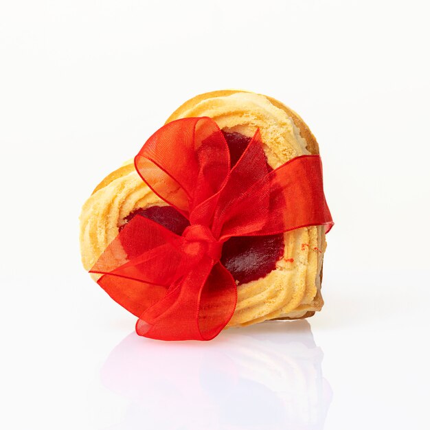 Heart shaped cookies tied with a red bow isolated on white background. Valentine's Day or Birthday Concept.