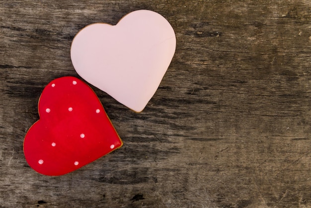 Heart shaped cookies for valentine day on rustic wooden table. Top view