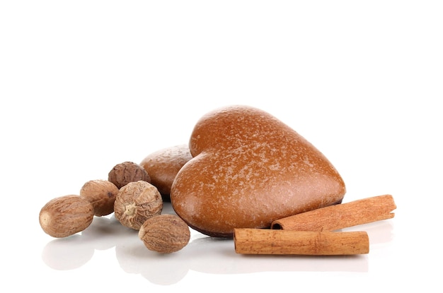 Heart-shaped cookies with cinnamon and nutmegs isolated on white