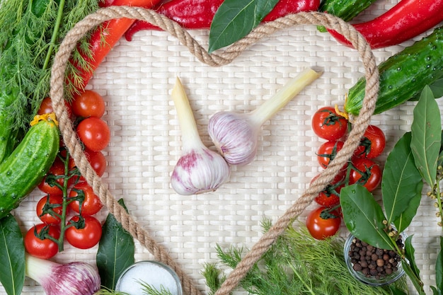 A heart shaped frame with vegetables and herbs