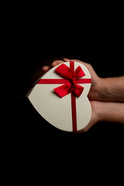 Heart shaped gift box in hands