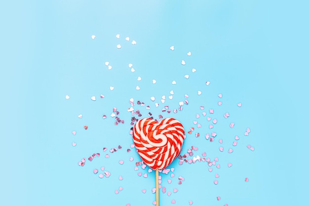 Photo heart shaped lollipop over blue background